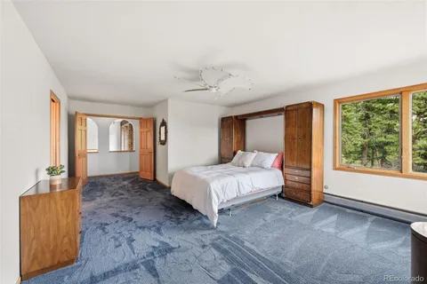 a spacious bedroom with a large bed and a window