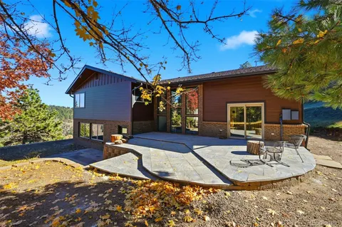 a view of a house with backyard and sitting area