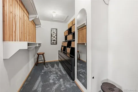 a view of hallway with stairs and furniture