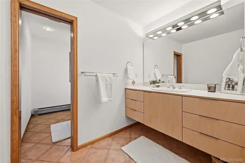 a bathroom with a double vanity sink a mirror and a bathtub