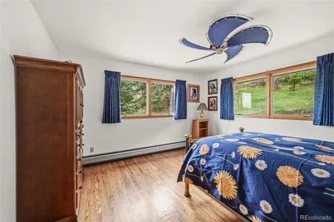 a bedroom with a bed and a large window