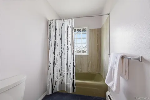 a bathroom with a shower curtain and a sink