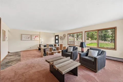 a living room with furniture and large windows