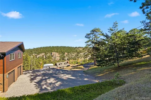 a view of a yard with a house in the background