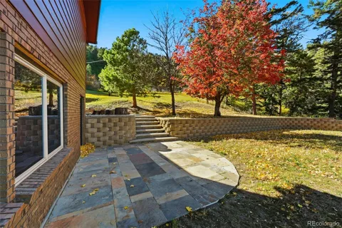 a view of a yard with wooden fence