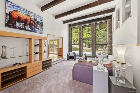 a living room with furniture and large windows