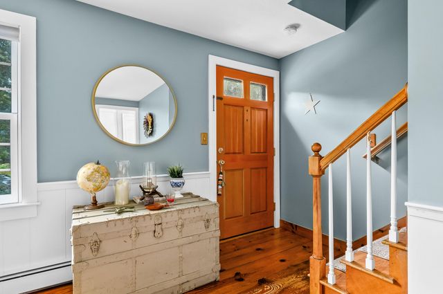 a room with round mirror and cabinets
