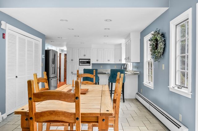 a kitchen with stainless steel appliances kitchen island granite countertop a refrigerator and microwave