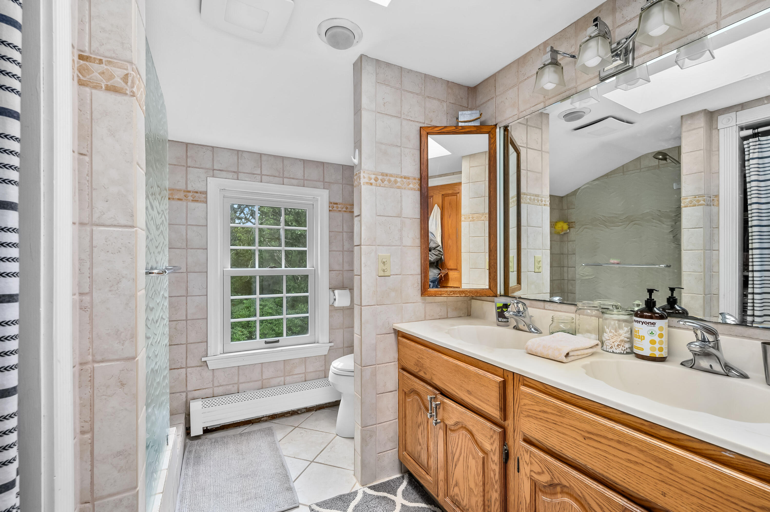 42 Marble Road Barnstable, MA 02630 - Photo 29 of 37 a bathroom with a double vanity sink mirror and a bathtub