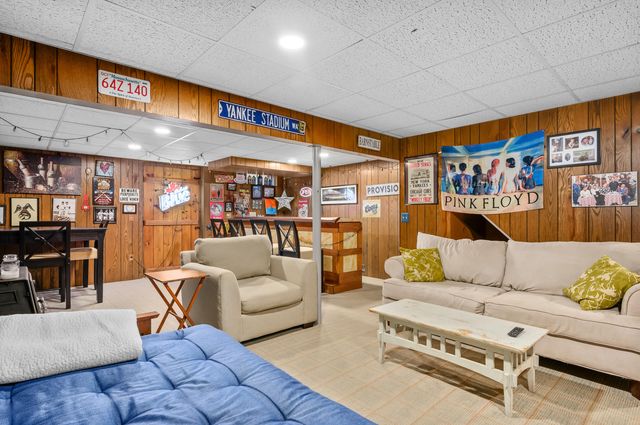 a living room with furniture a table and a flat screen tv