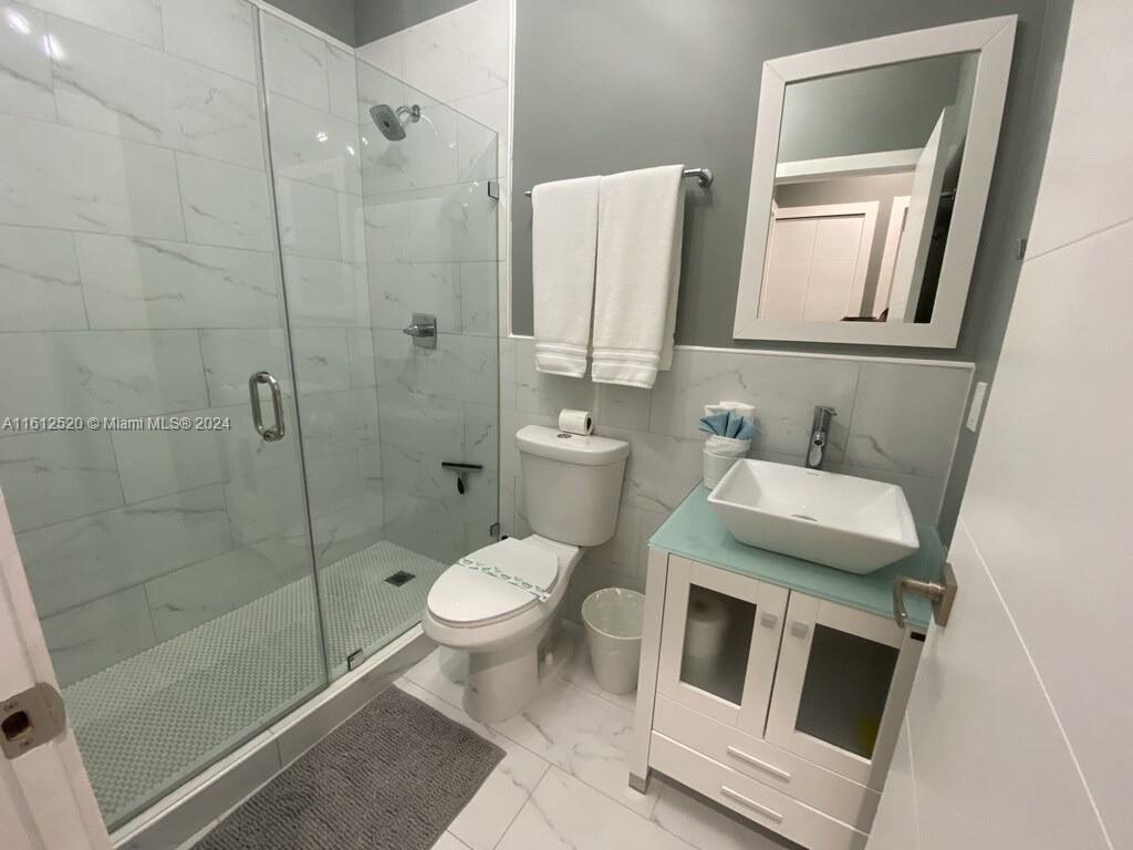 3445 Southwest 14th Street, Unit 3445 Miami, FL 33145 - Photo 11 of 52 a bathroom with a toilet sink and shower