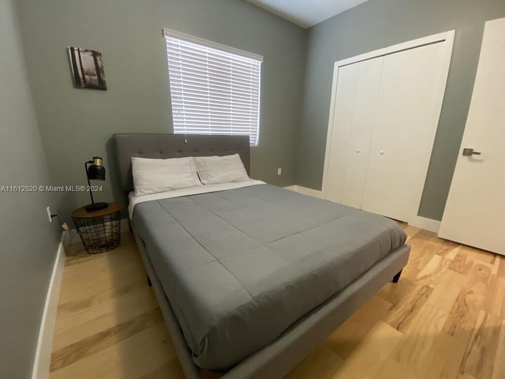 3445 Southwest 14th Street, Unit 3445 Miami, FL 33145 - Photo 17 of 52 a bed sitting in a bedroom next to a window