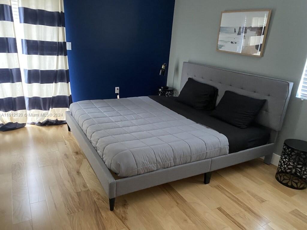 3445 Southwest 14th Street, Unit 3445 Miami, FL 33145 - Photo 25 of 52 a bedroom with a bed and wooden floor