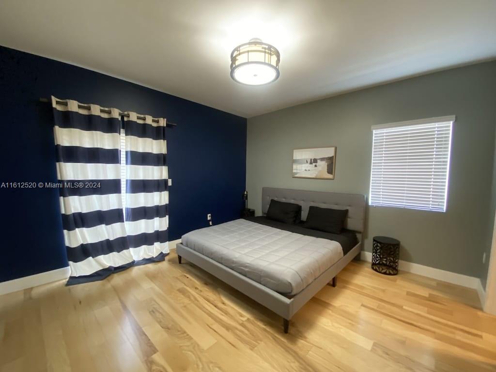 3445 Southwest 14th Street, Unit 3445 Miami, FL 33145 - Photo 26 of 52 a bedroom with a large bed and a window