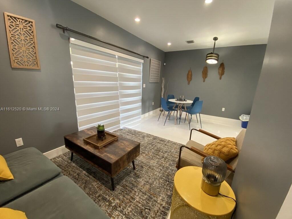 3445 Southwest 14th Street, Unit 3445 Miami, FL 33145 - Photo 31 of 52 a living room with furniture a rug and a window