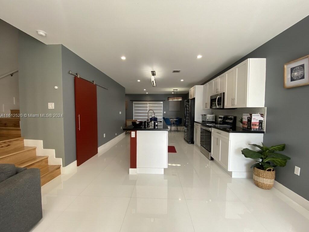 3445 Southwest 14th Street, Unit 3445 Miami, FL 33145 - Photo 45 of 52 a kitchen with a refrigerator and microwave