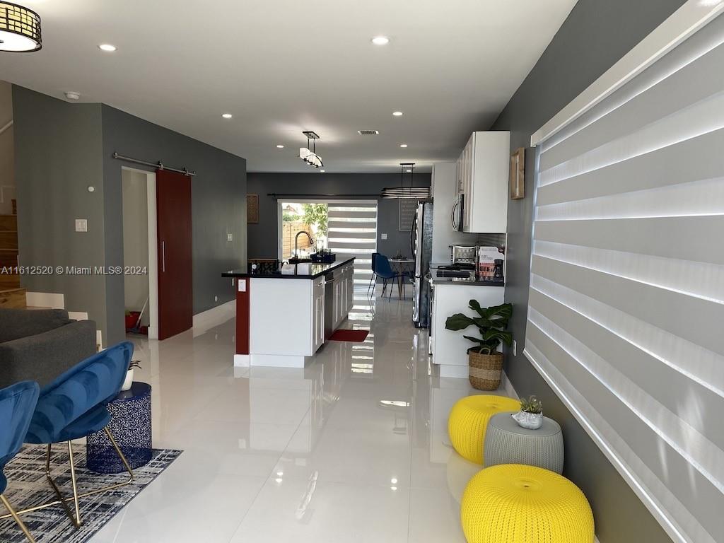 3445 Southwest 14th Street, Unit 3445 Miami, FL 33145 - Photo 47 of 52 a living room with stainless steel appliances furniture a rug and a kitchen view