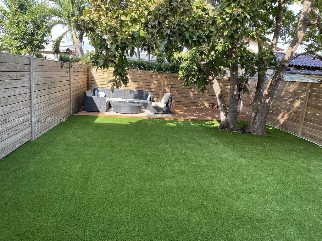 3445 Southwest 14th Street, Unit 3445 Miami, FL 33145 - Photo 6 of 52 a view of a garden with a bench