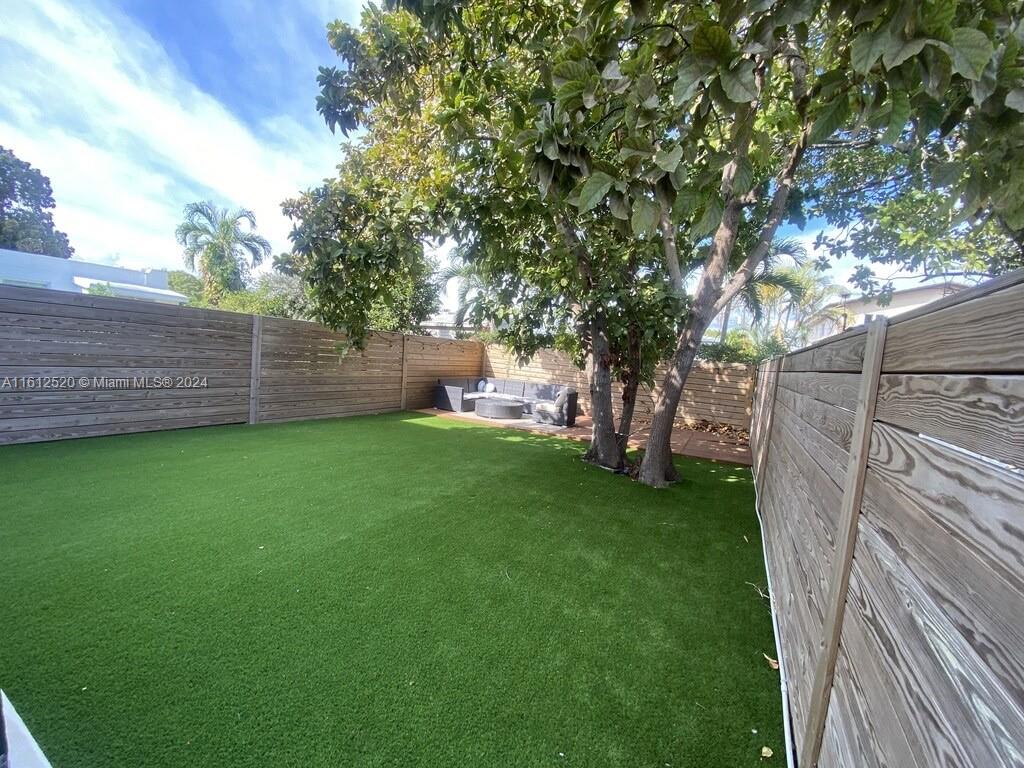 3445 Southwest 14th Street, Unit 3445 Miami, FL 33145 - Photo 7 of 52 a view of a backyard with a large tree
