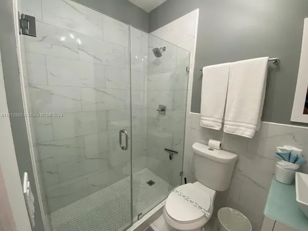 a bathroom with a toilet sink and shower