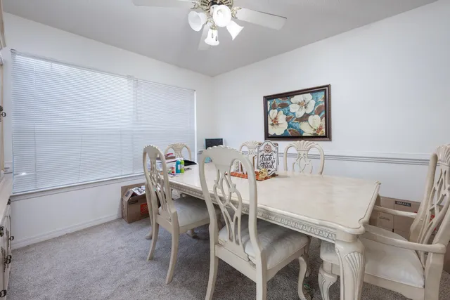 a view of a dining room with furniture and chandelier