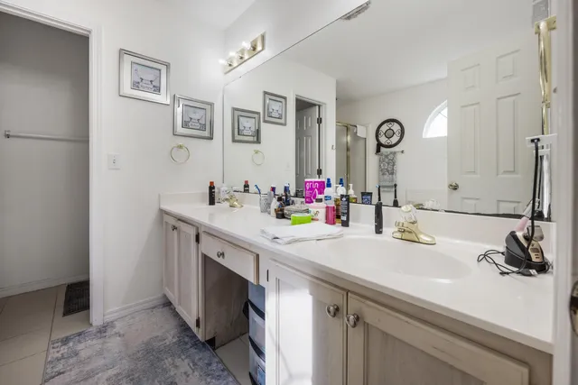a spacious bathroom with a double vanity sink mirror and toilet