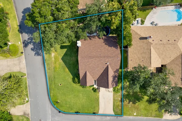 an aerial view of a house with a swimming pool