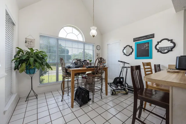 a kitchen with stainless steel appliances granite countertop a dining table chairs and granite counter tops