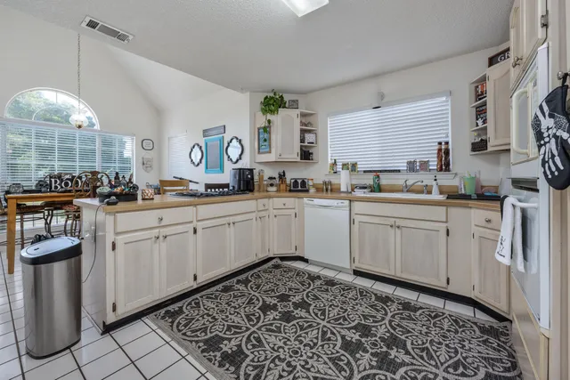 a kitchen with stainless steel appliances a refrigerator sink and cabinets