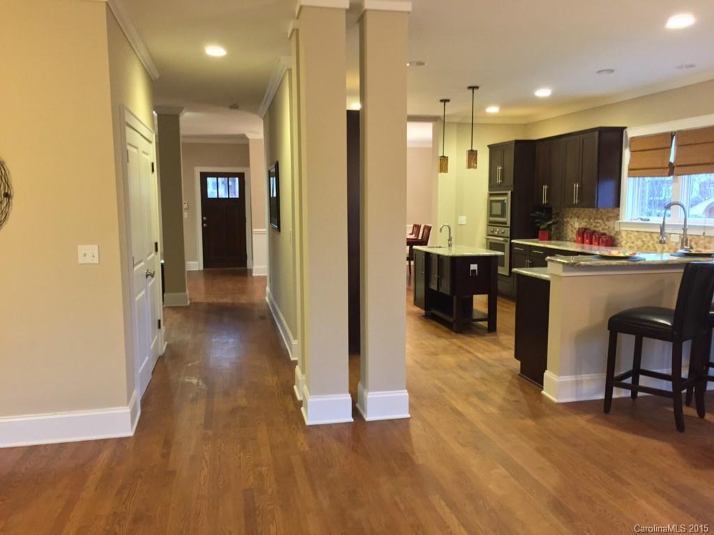 521 Grandin Road Charlotte, NC 28208 - Photo 12 of 23 a view of a kitchen with kitchen island granite countertop wooden floor and a refrigerator
