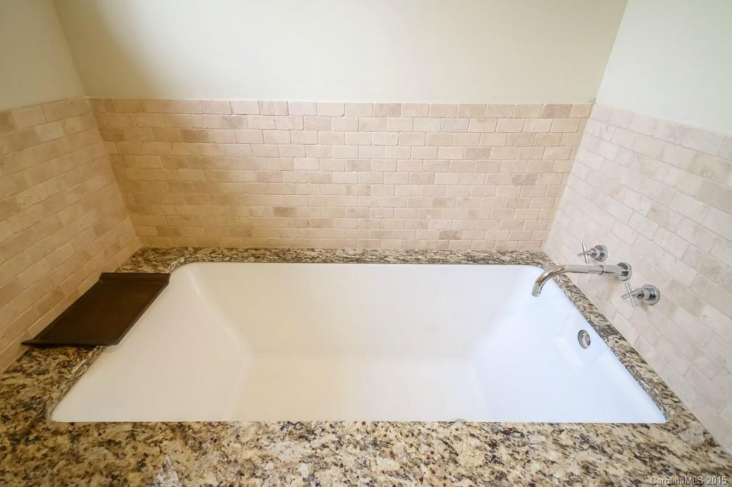521 Grandin Road Charlotte, NC 28208 - Photo 17 of 23 a bath tub sitting in a bathroom and a sink