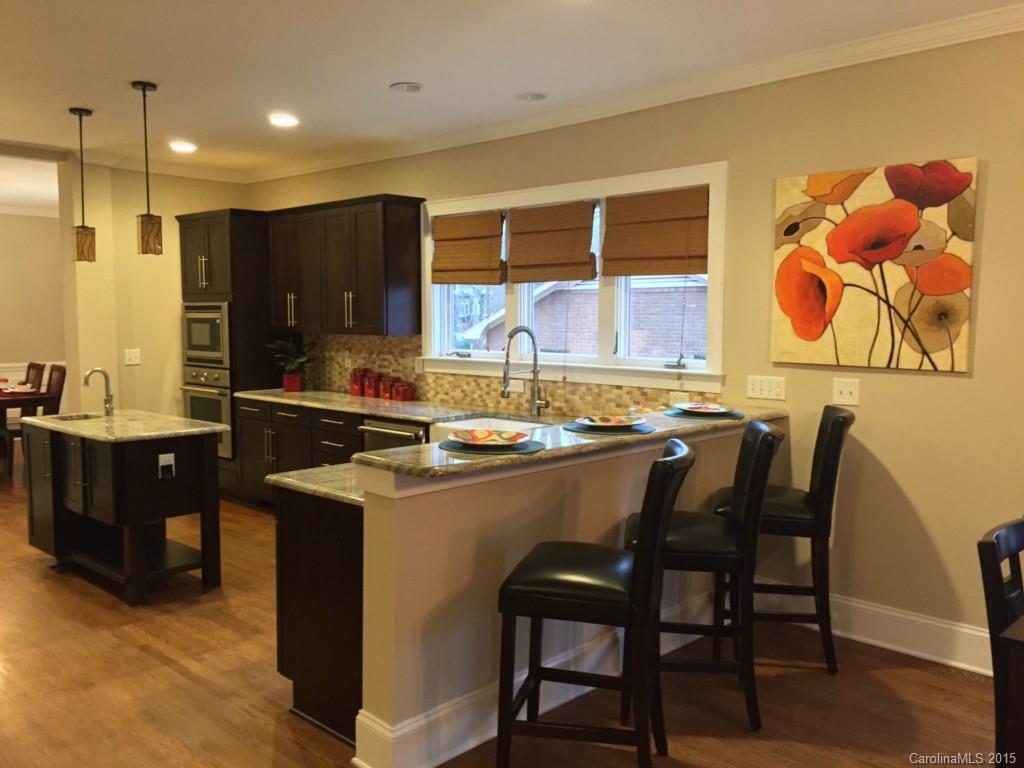 521 Grandin Road Charlotte, NC 28208 - Photo 6 of 23 a kitchen with a sink and chairs