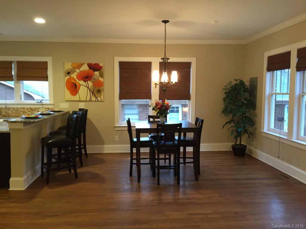 521 Grandin Road Charlotte, NC 28208 - Photo 7 of 23 a view of a dining room and livingroom with furniture wooden floor a chandelier