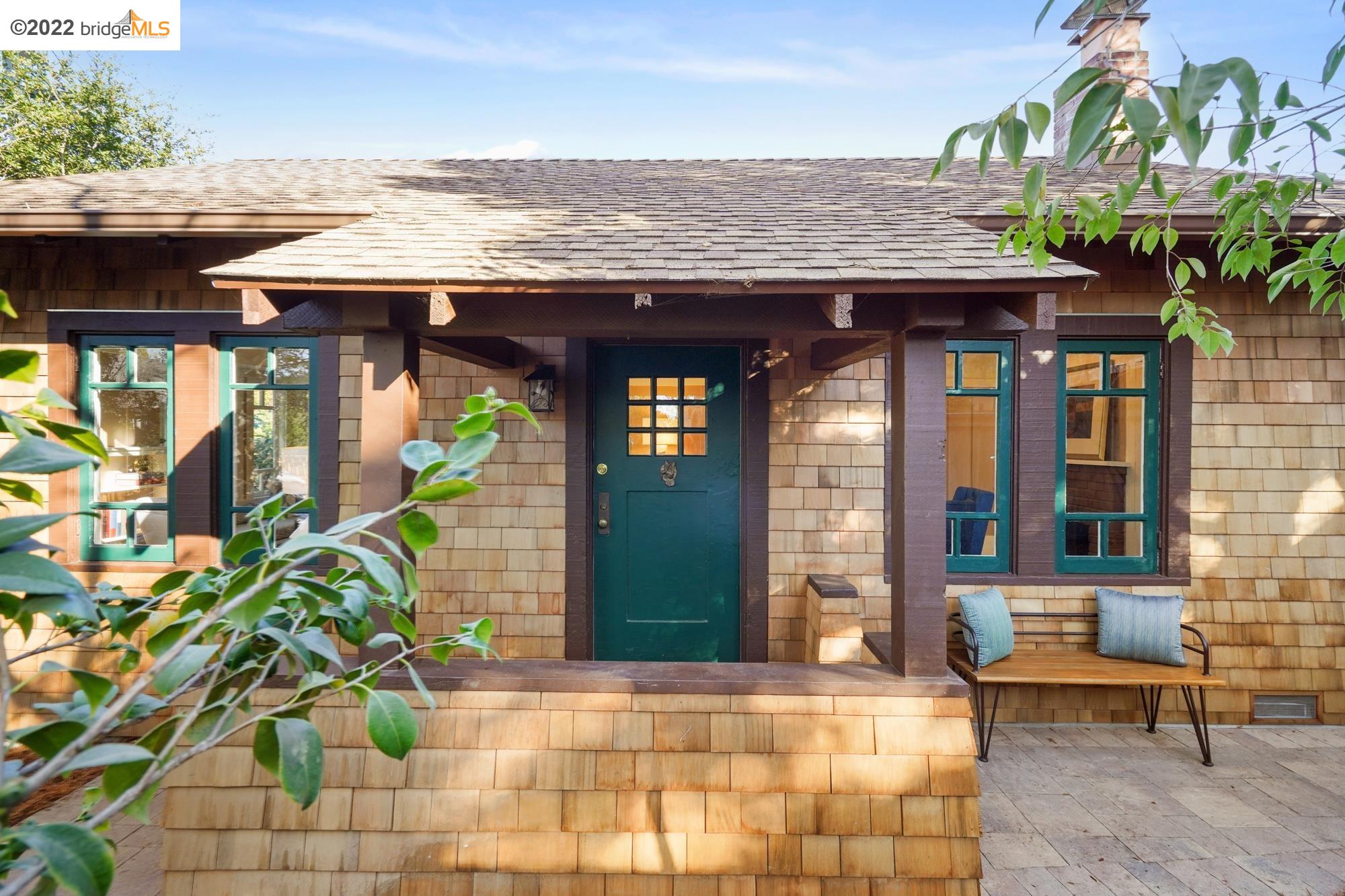 a view of a brick house with potted plants