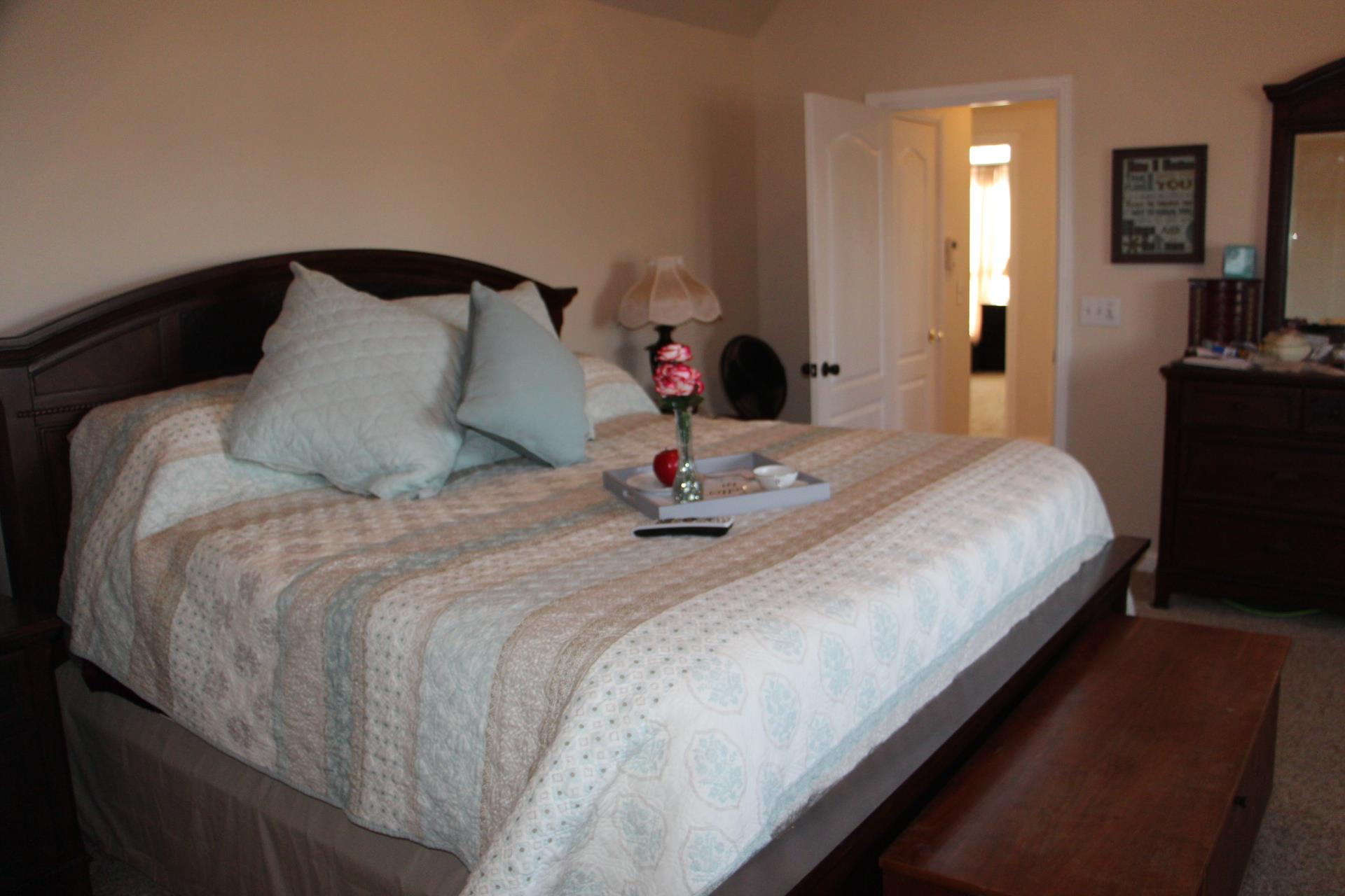 4373 Oregon Road Springfield, TN 37172 - Photo 13 of 18 a large bed sitting in a bedroom and a mirror