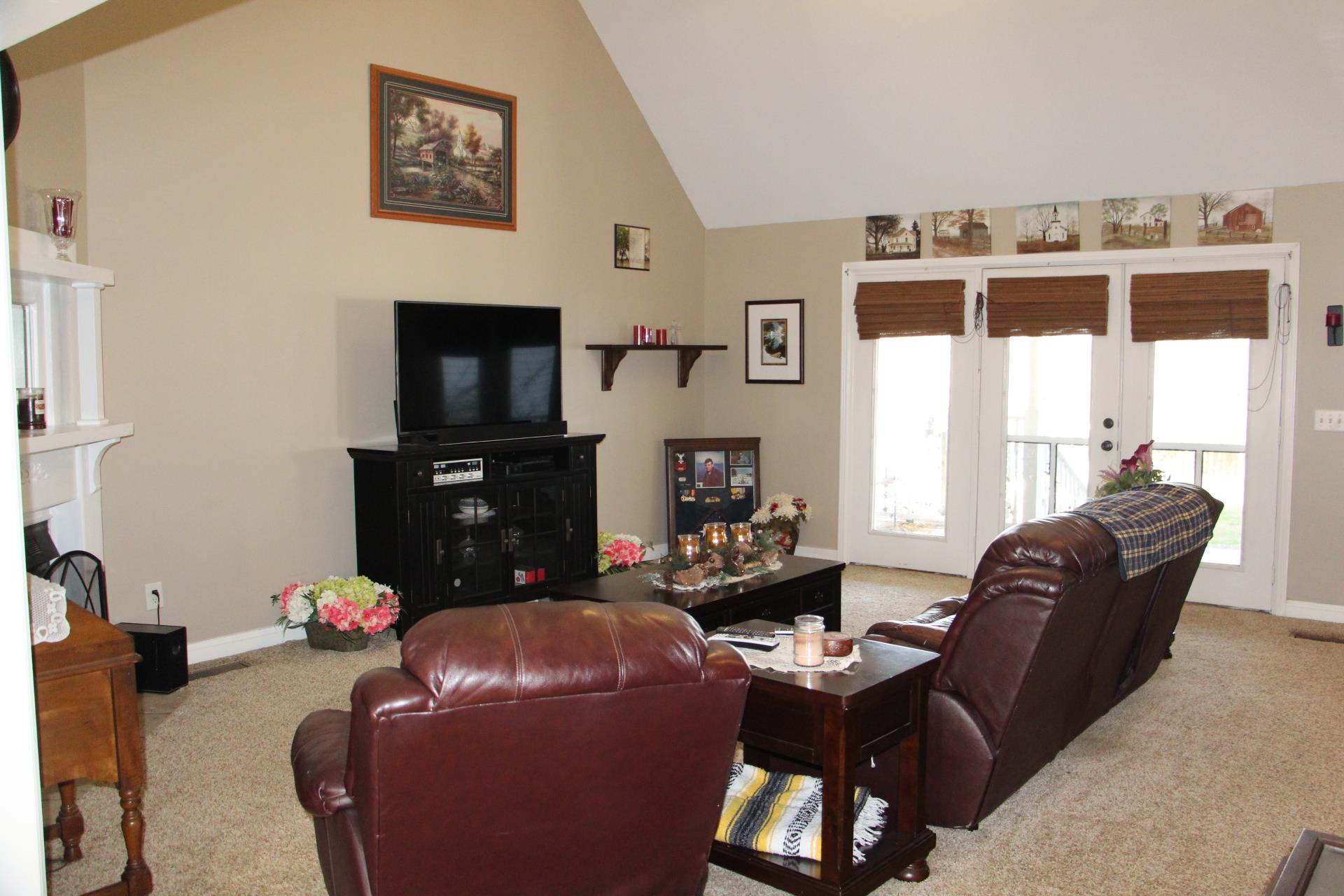 4373 Oregon Road Springfield, TN 37172 - Photo 17 of 18 a living room with furniture a flat screen tv and a floor to ceiling window