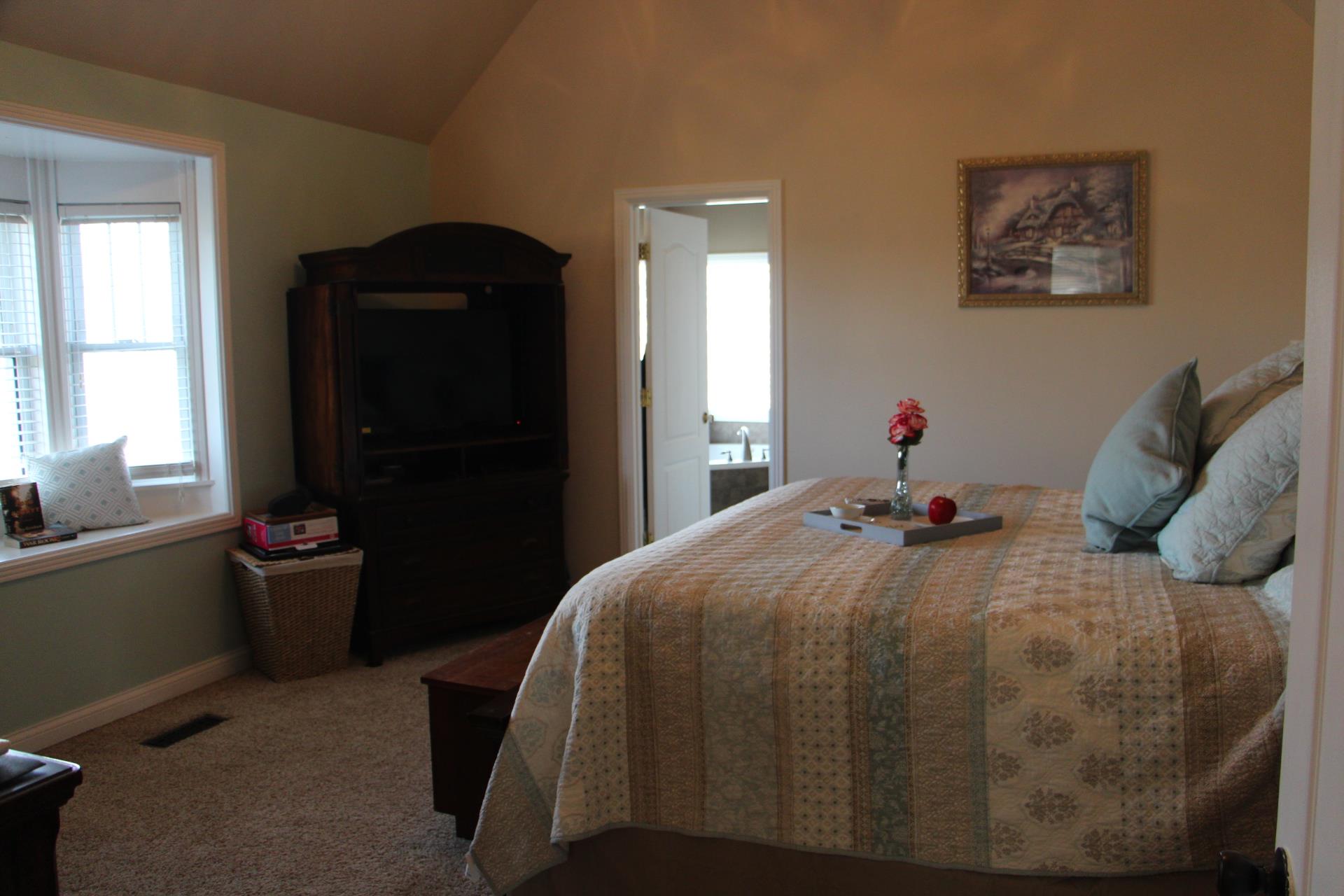 4373 Oregon Road Springfield, TN 37172 - Photo 10 of 18 a bed sitting in a bedroom next to a window