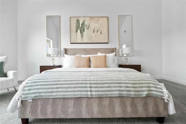 a bedroom with a bed and painting on the wall