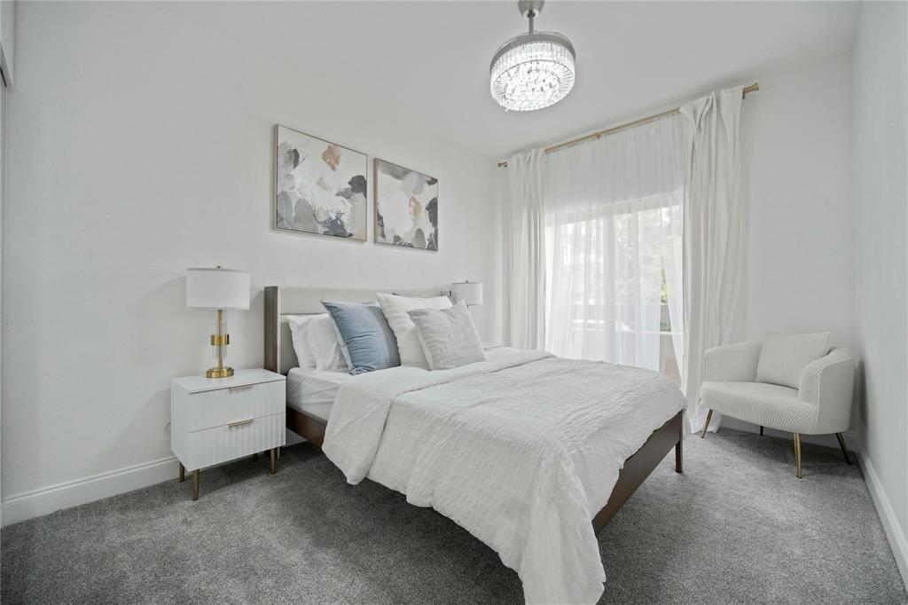 6230 Dewitt Street Sachse, TX 75048 - Photo 18 of 21 Carpeted bedroom with baseboards and a chandelier