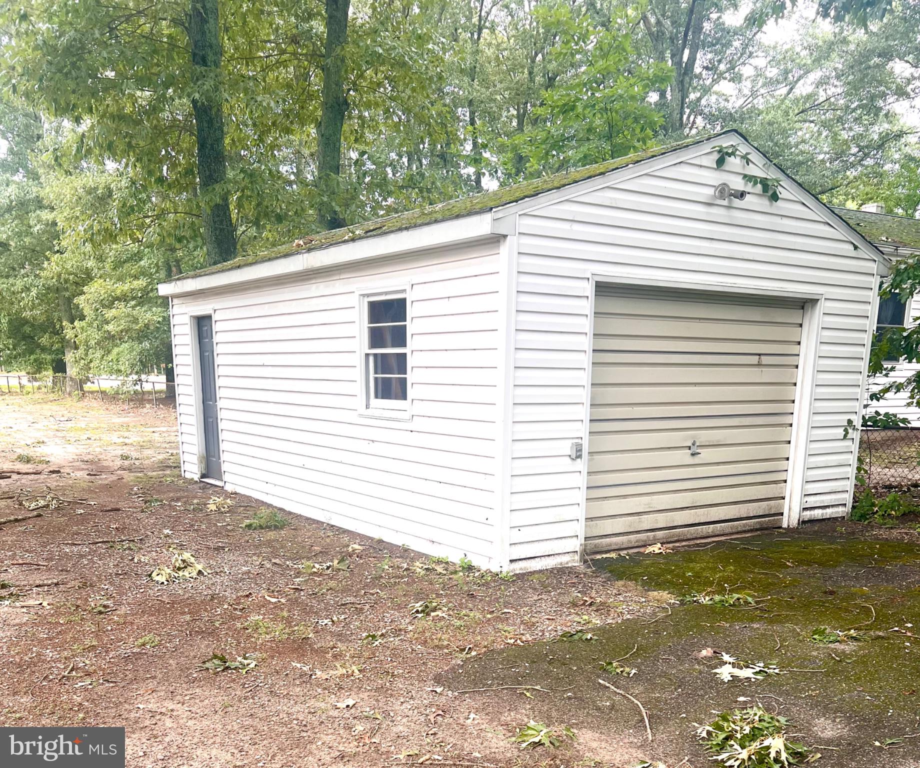 26576 Three Notch Road Mechanicsville, MD 20659 - Photo 19 of 20 Charming white garage in serene setting.