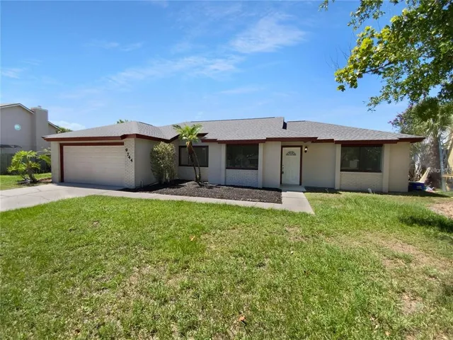 a front view of a house with a garden and yard