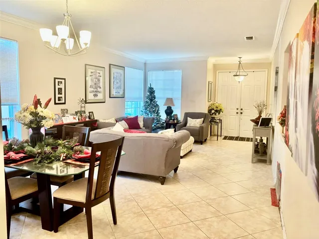a living room with fireplace furniture and a chandelier