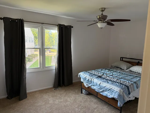 a bedroom with a bed and window