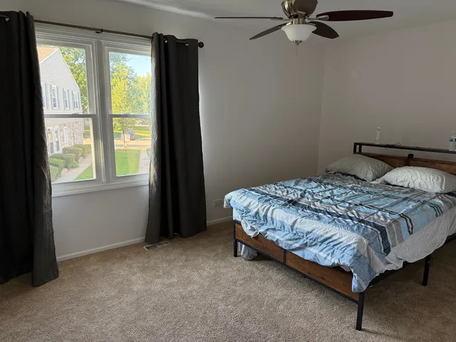 a bathroom with a granite countertop toilet sink and mirror