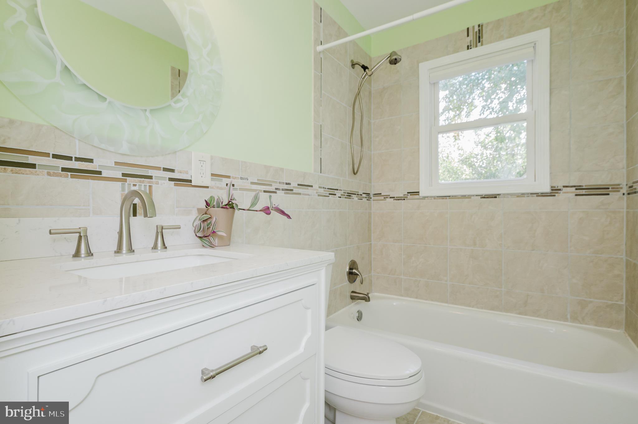 5501 Catalpha Road Baltimore, MD 21214 - Photo 19 of 40 a bathroom with a sink a toilet and a bathtub