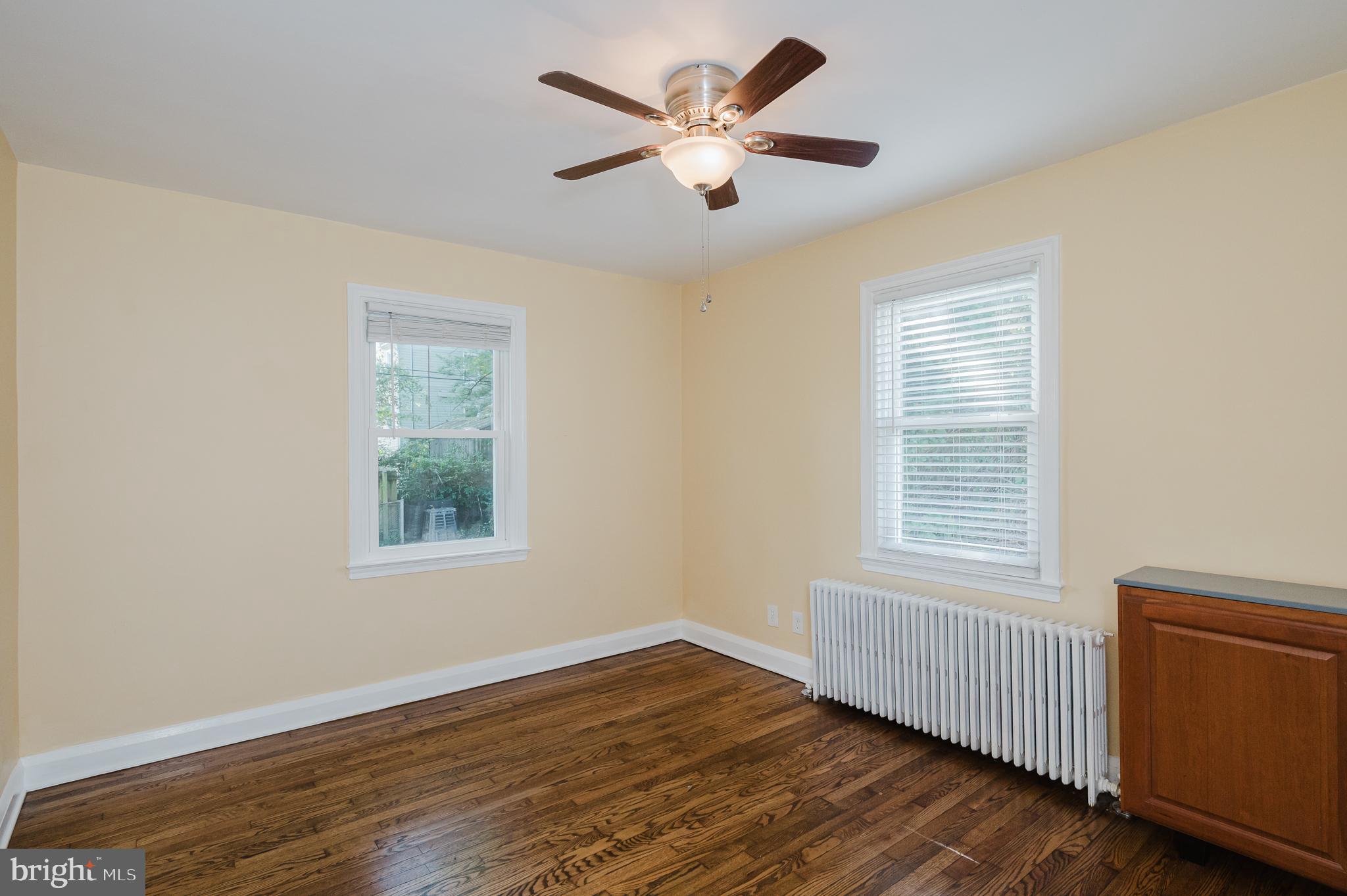 5501 Catalpha Road Baltimore, MD 21214 - Photo 21 of 40 a view of an empty room with wooden floor and a window