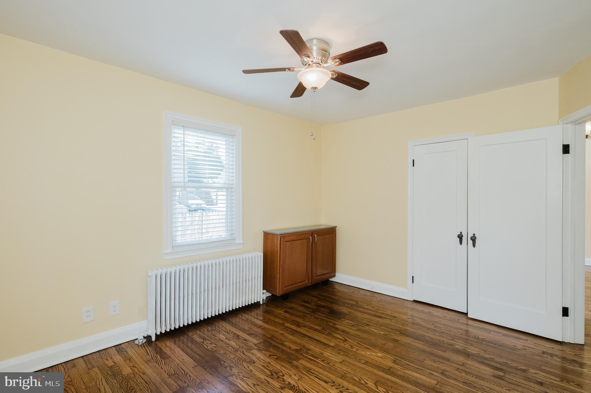 5501 Catalpha Road Baltimore, MD 21214 - Photo 22 of 40 a view of an empty room with wooden floor and a window