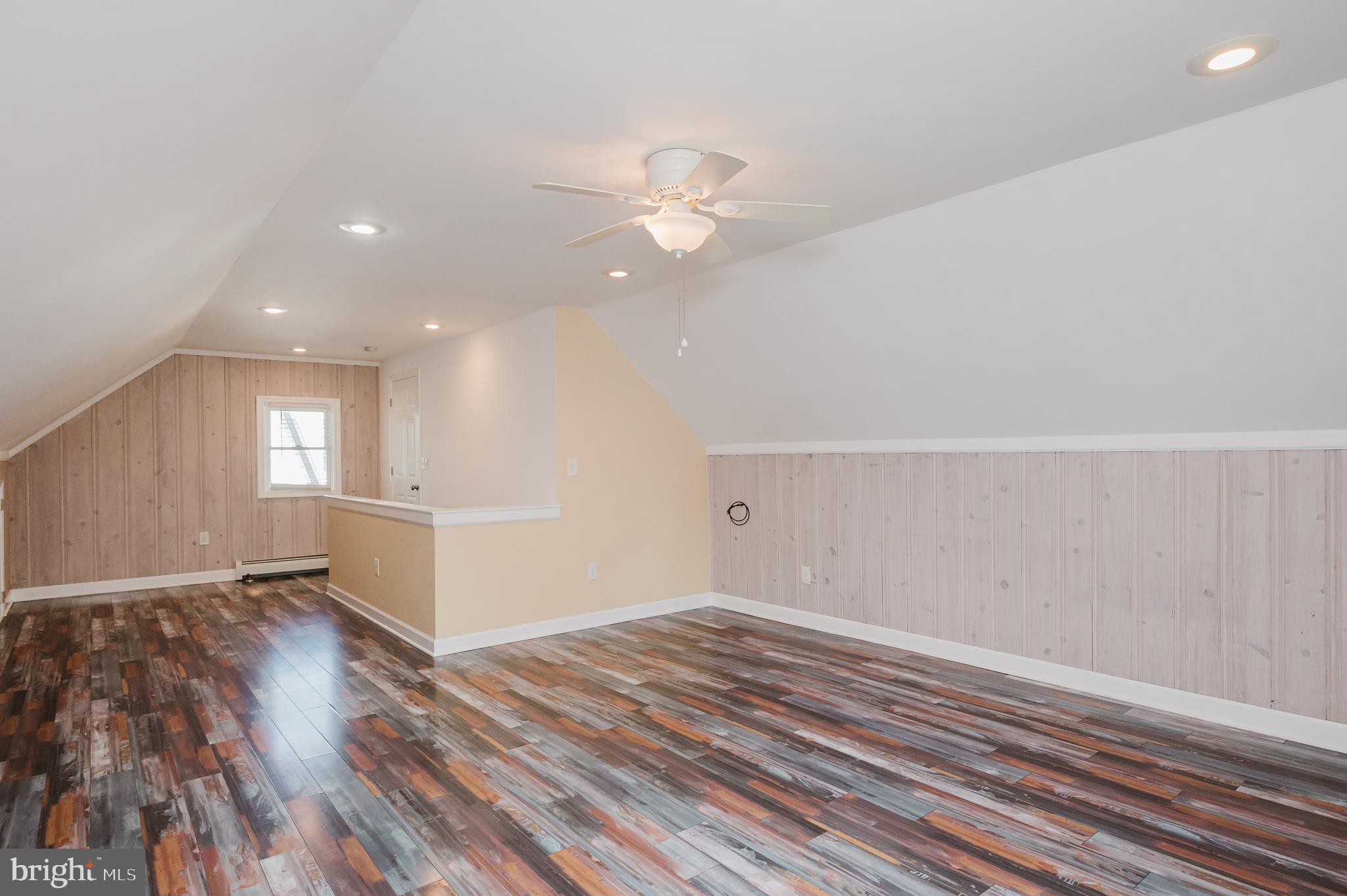 5501 Catalpha Road Baltimore, MD 21214 - Photo 25 of 40 an empty room with wooden floor fan and window