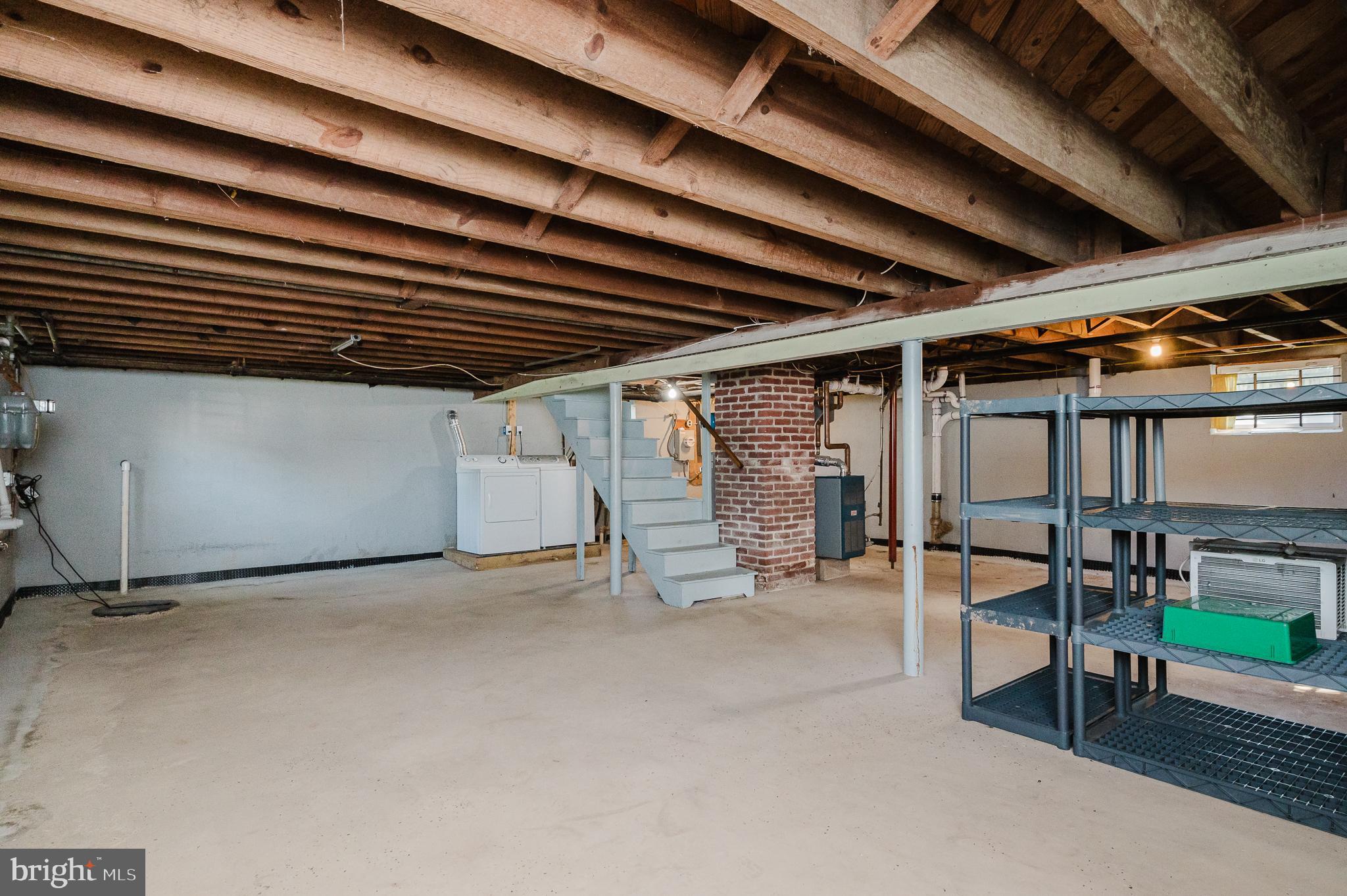 5501 Catalpha Road Baltimore, MD 21214 - Photo 33 of 40 a view of an empty room with wooden floor and a window