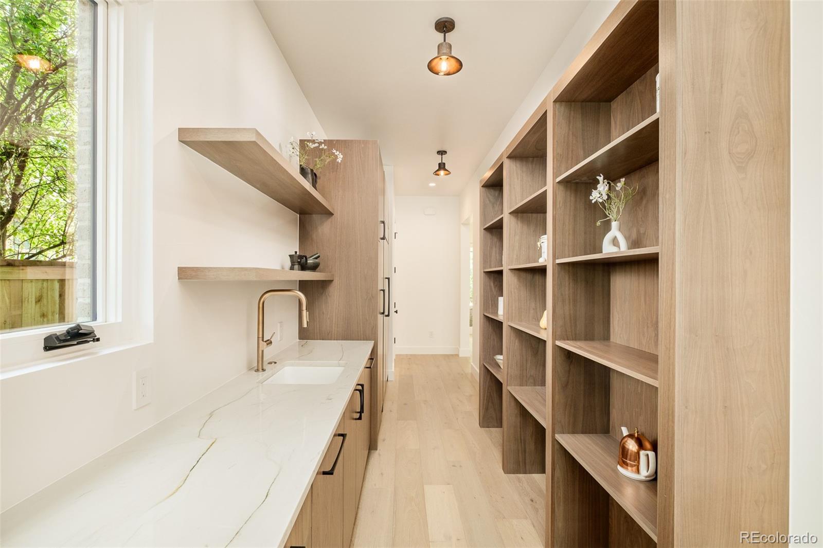 1253 South High Street Denver, CO 80210 - Photo 19 of 46 a bathroom with a sink and a window